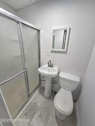 a bathroom with a sink toilet and a mirror