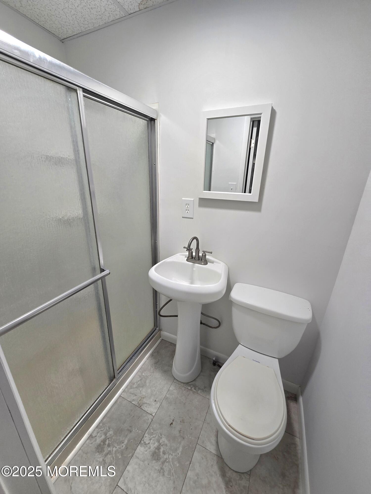 1010 Sewall Avenue, Unit 1 Asbury Park, NJ 07712 - Photo 4 of 6 a bathroom with a sink toilet and a mirror