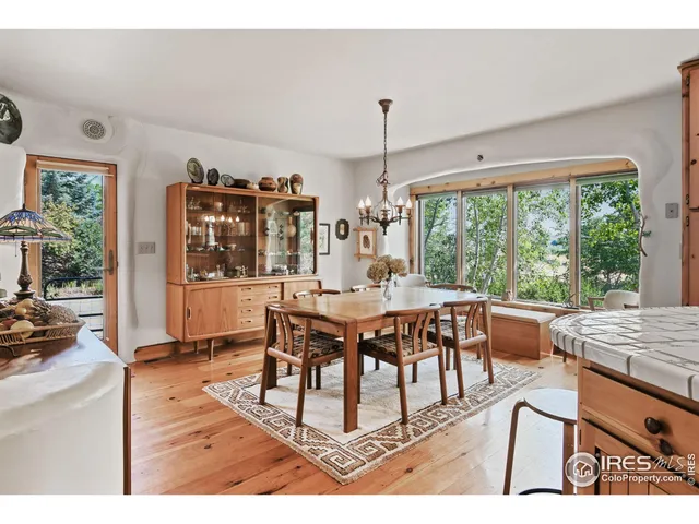 a dining room with furniture window and wooden floor