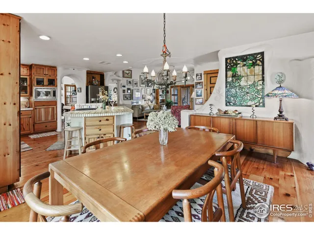 a room with stainless steel appliances kitchen island a table and chairs in it