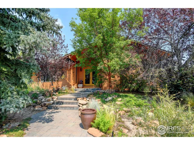 a view of a backyard with table and chairs and potted plants