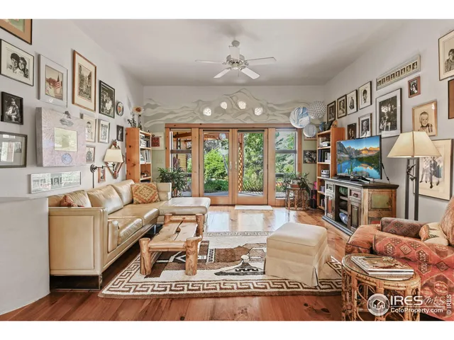 a living room with furniture a flat screen tv and a rug