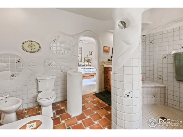a bathroom with a sink a toilet and a shower