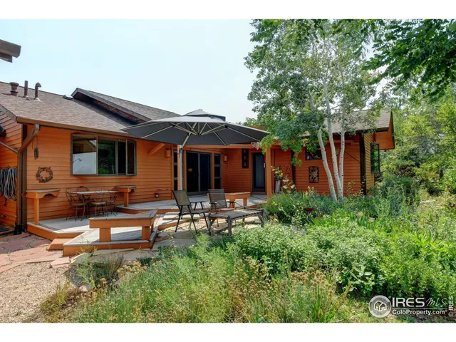 a view of a house with backyard sitting area and garden