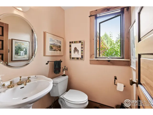 a bathroom with a toilet a sink and a mirror