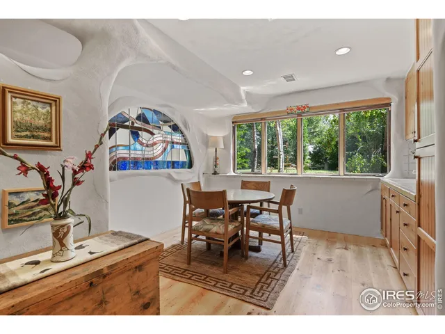 a living room with furniture a window and a flat screen tv
