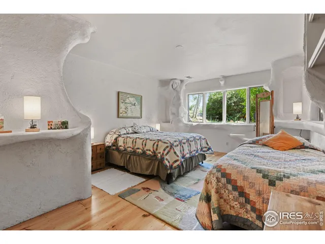 a bedroom with double bed and a window