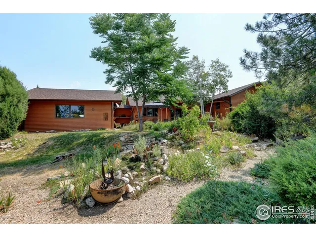 a backyard of a house with a yard and outdoor seating