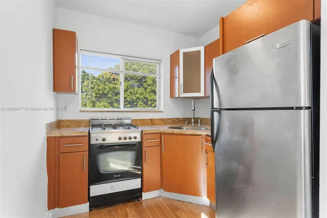 a kitchen with a stove and a refrigerator