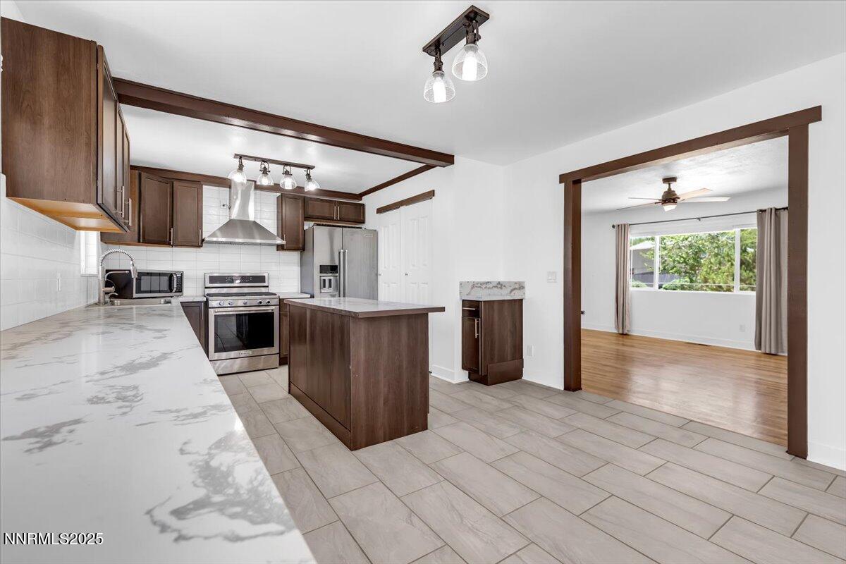 1340 Rayburn Drive Reno, NV 89503 - Photo 11 of 42 a kitchen with stainless steel appliances granite countertop a stove top oven a sink a counter space and cabinets