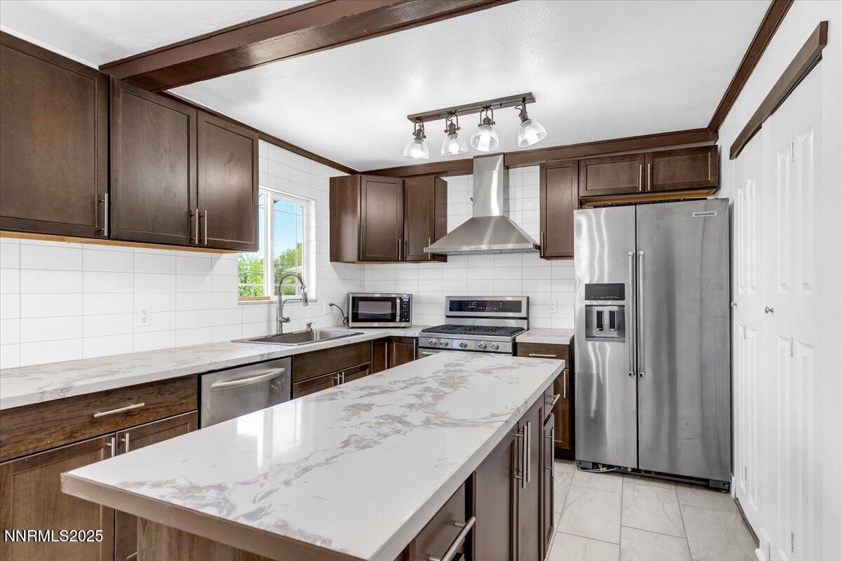 1340 Rayburn Drive Reno, NV 89503 - Photo 14 of 42 a kitchen with stainless steel appliances a sink stove refrigerator and cabinets