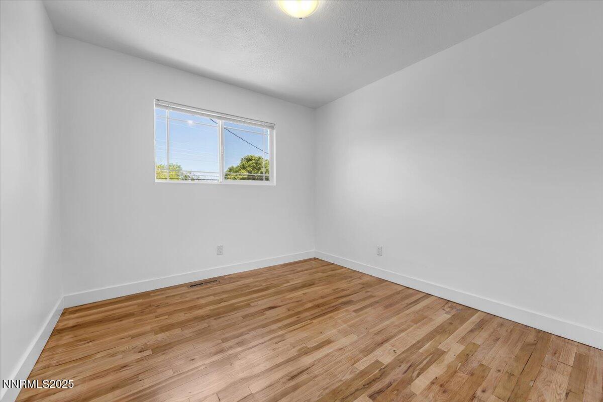 1340 Rayburn Drive Reno, NV 89503 - Photo 24 of 42 a view of an empty room with wooden floor and a window