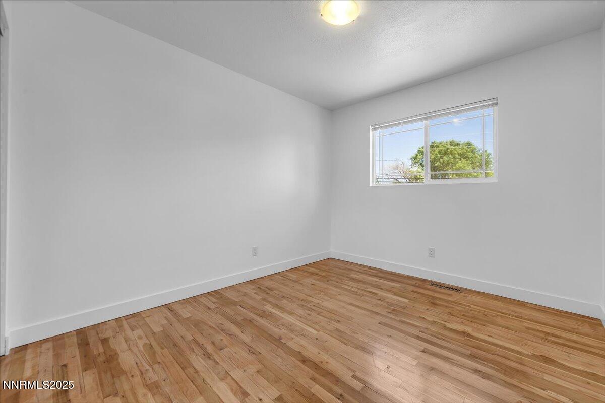 1340 Rayburn Drive Reno, NV 89503 - Photo 26 of 42 an empty room with wooden floor and a window