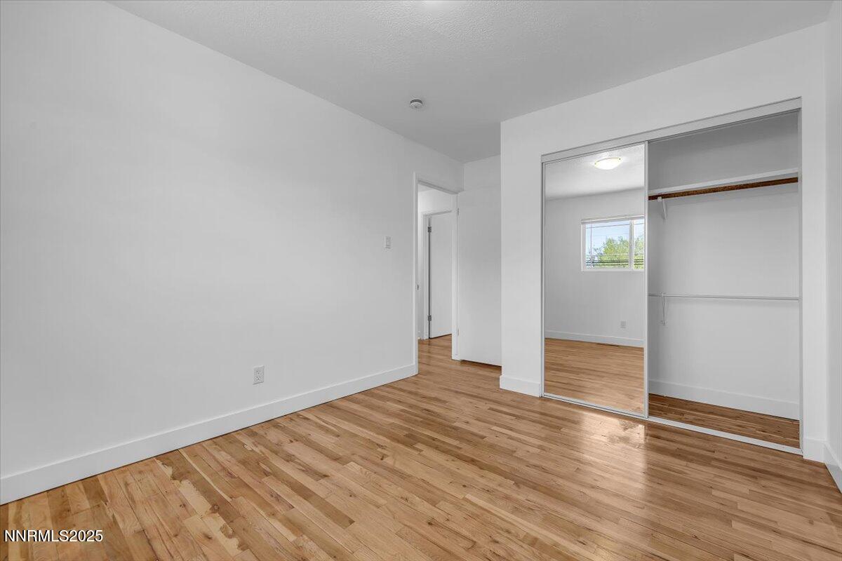 1340 Rayburn Drive Reno, NV 89503 - Photo 27 of 42 a view of an empty room with wooden floor and a window