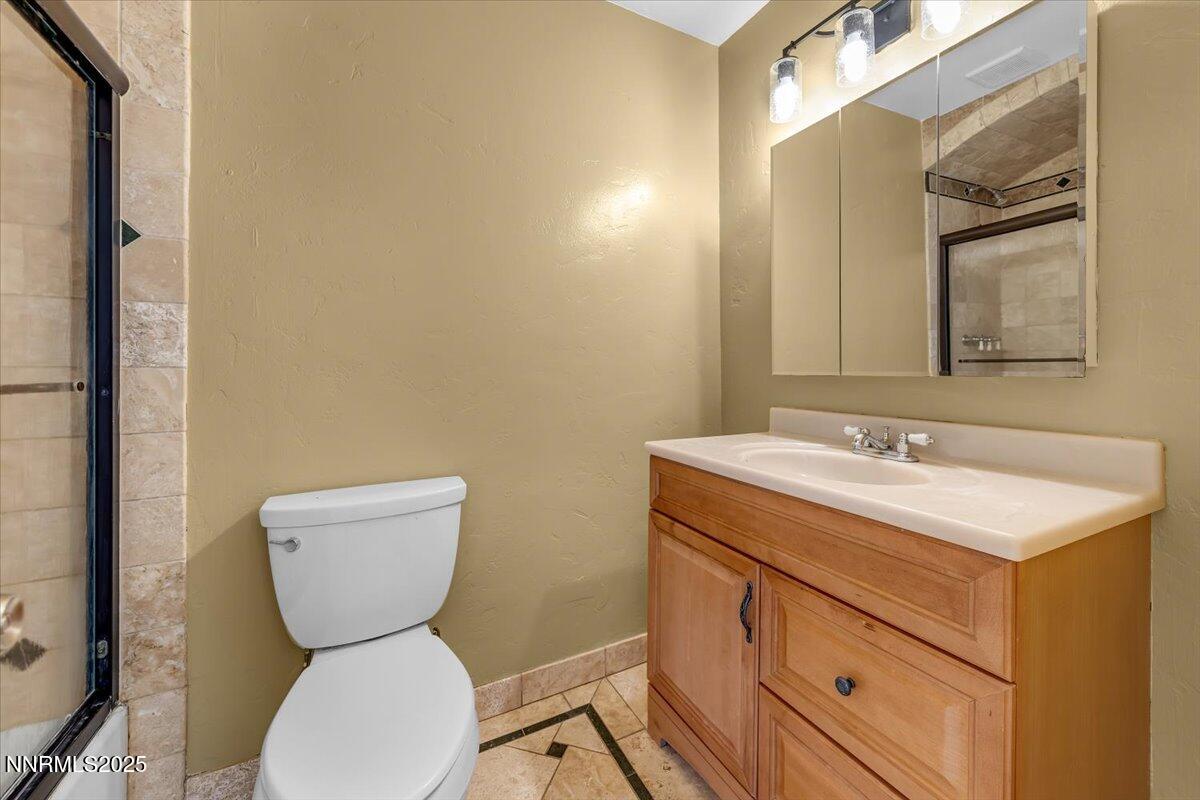 1340 Rayburn Drive Reno, NV 89503 - Photo 28 of 42 a bathroom with a toilet sink and mirror