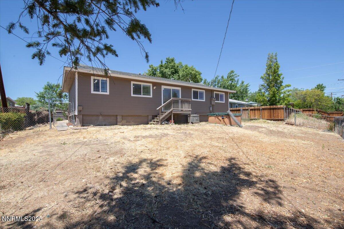 1340 Rayburn Drive Reno, NV 89503 - Photo 35 of 42 a backyard of a house with table and chairs under an umbrella
