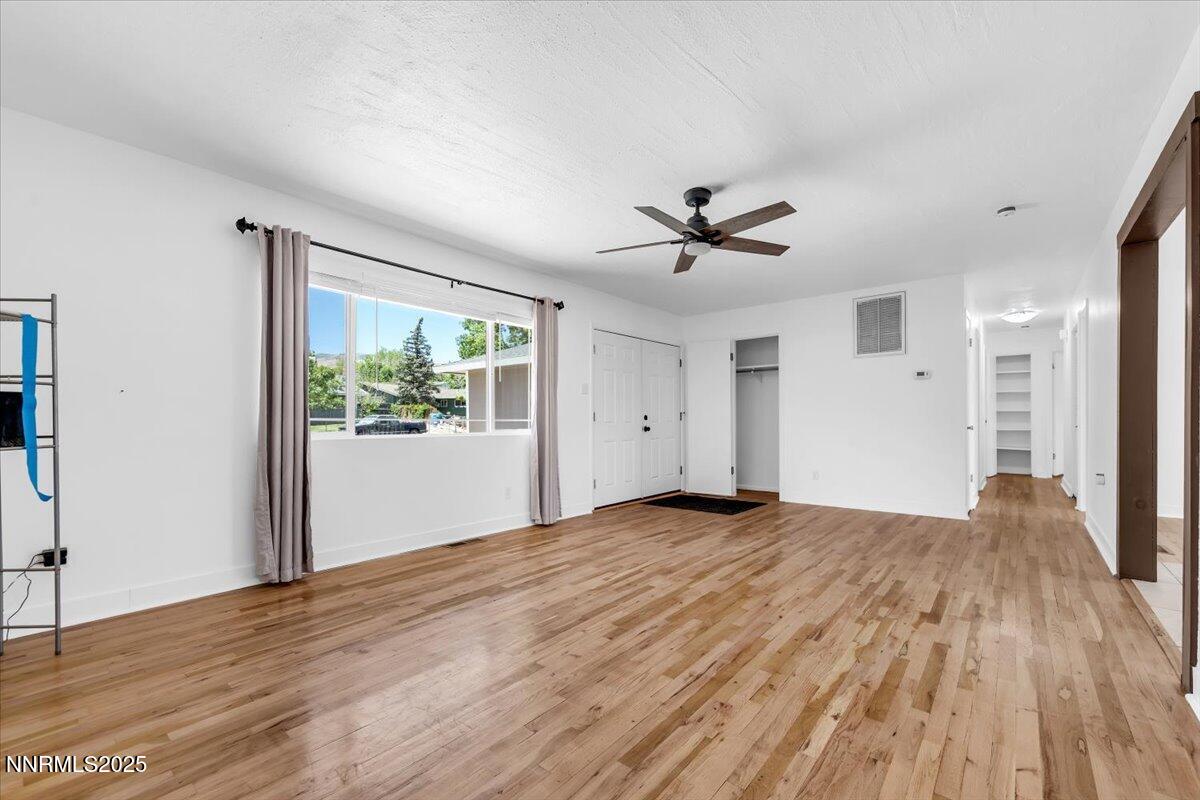 1340 Rayburn Drive Reno, NV 89503 - Photo 8 of 42 a view of an empty room with wooden floor and a window