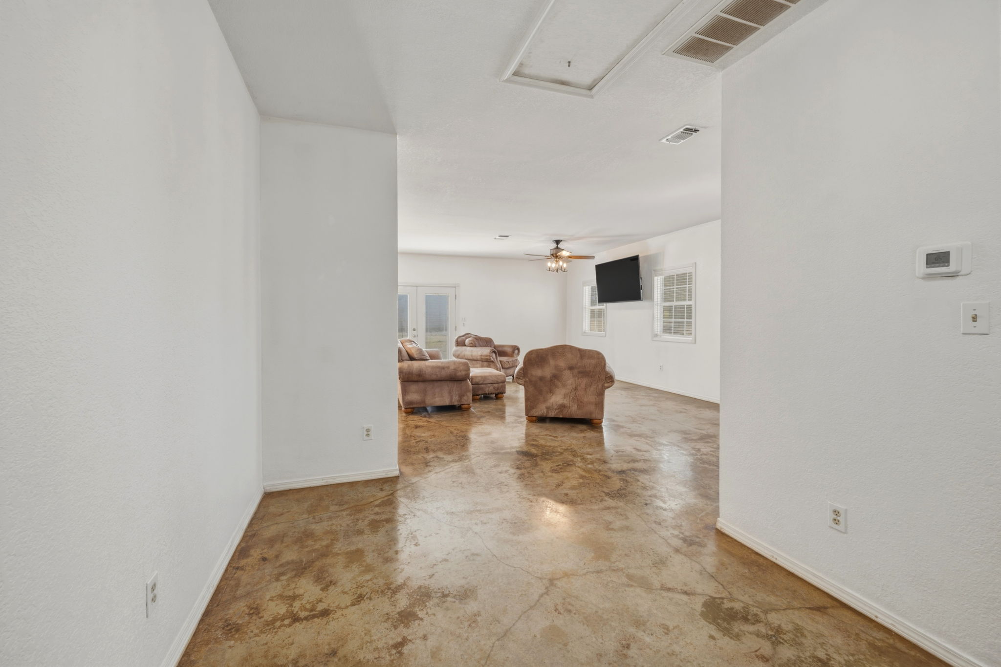 1301 Altwein Road Blanco, TX 78606 - Photo 19 of 40 Hall featuring finished concrete floors and attic access