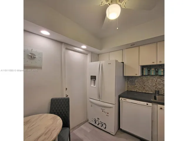 a kitchen with a refrigerator and a sink
