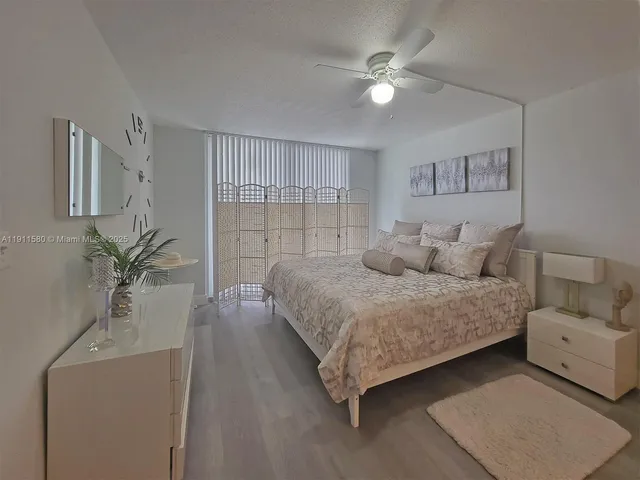 a bedroom with a large bed furniture and a window