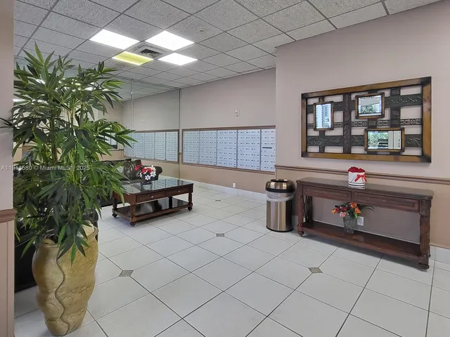 a kitchen with a potted plant on the counter and cabinets