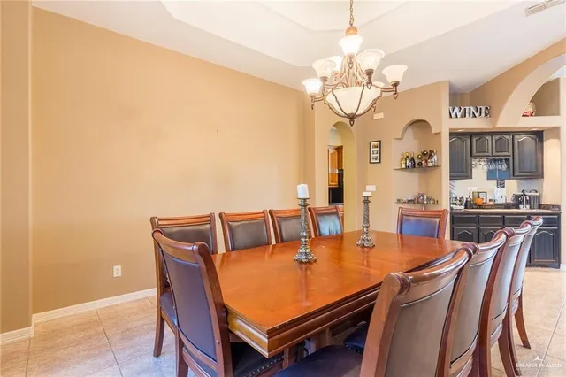 a dining room with furniture a chandelier and a rug