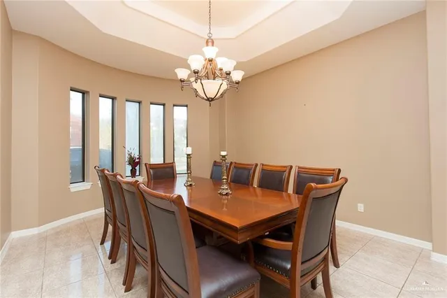 a view of a dining room with furniture a chandelier and wooden floor