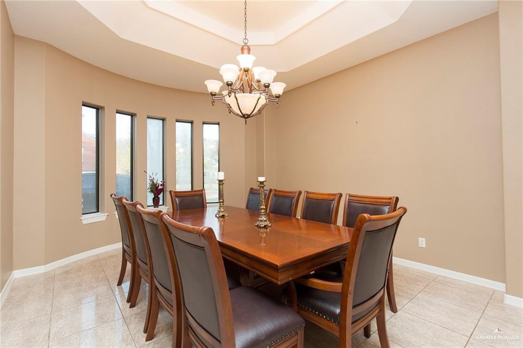 2802 South Pecan Boulevard Donna, TX 78537 - Photo 12 of 27 a view of a dining room with furniture a chandelier and wooden floor