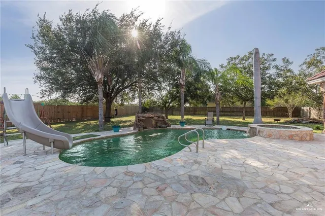 a view of a fountain with tree in the background