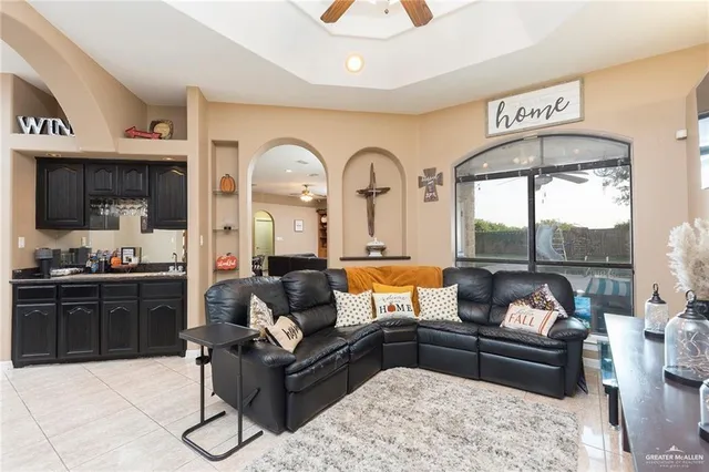 a living room with furniture and a floor to ceiling window