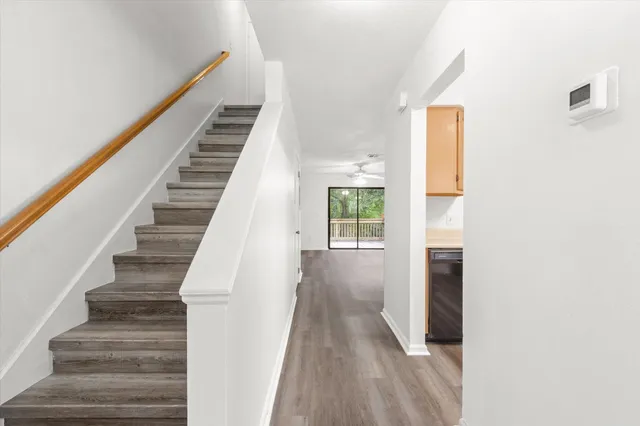 a view of entryway and hall with wooden floor