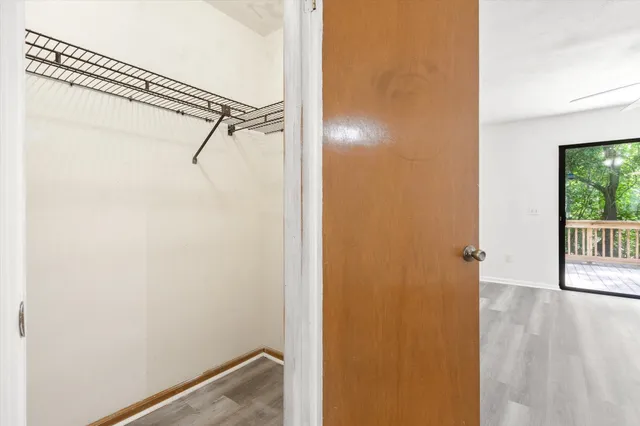 a view of a room with wooden floor and windows