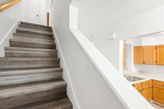 a view of entryway and hall with wooden floor