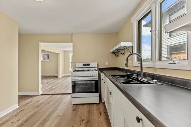 a kitchen with a sink stove and cabinets