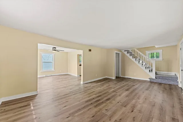a view of an empty room with wooden floor