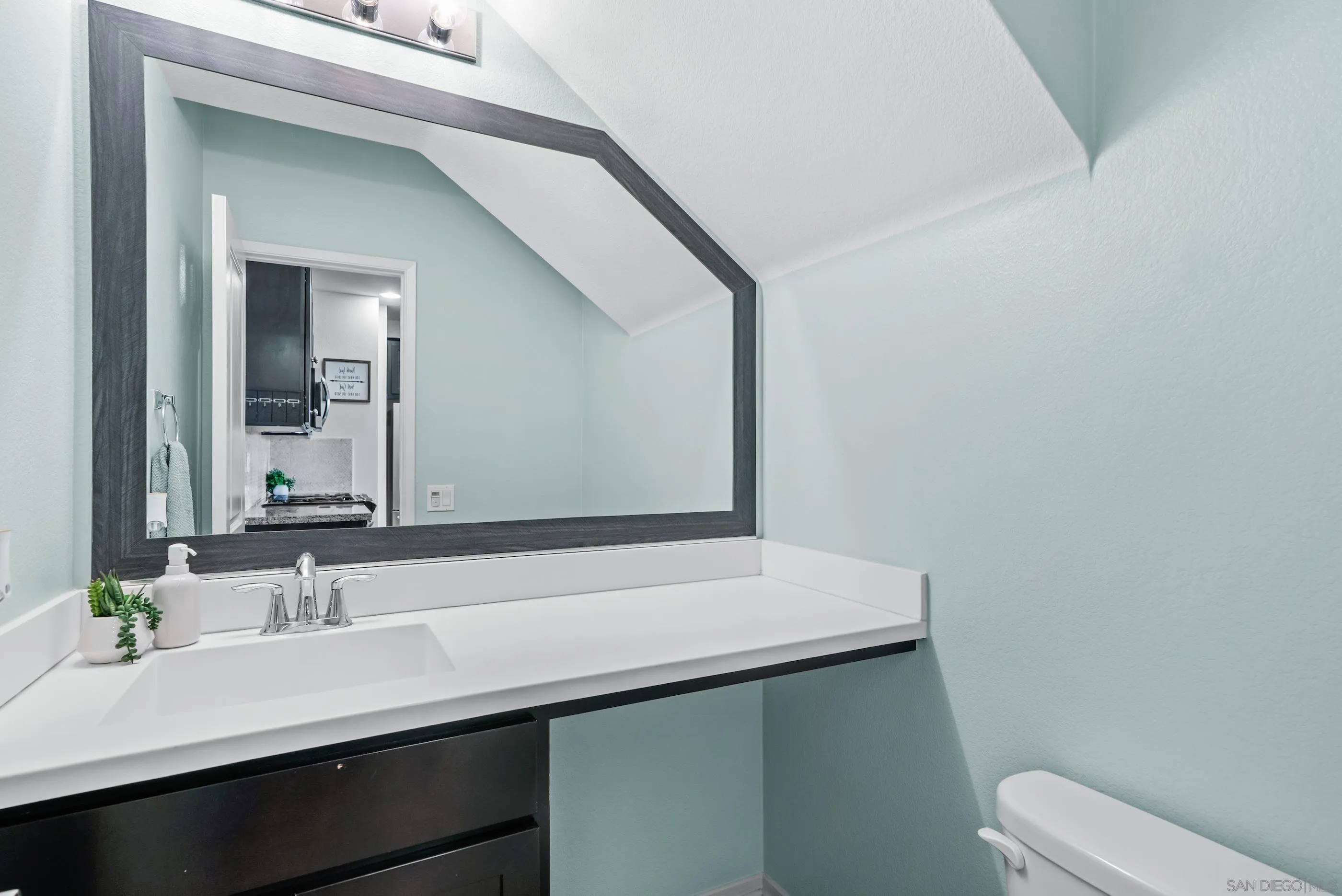 5481 San Roberto San Diego, CA 92154 - Photo 14 of 32 a bathroom with a sink a toilet and mirror