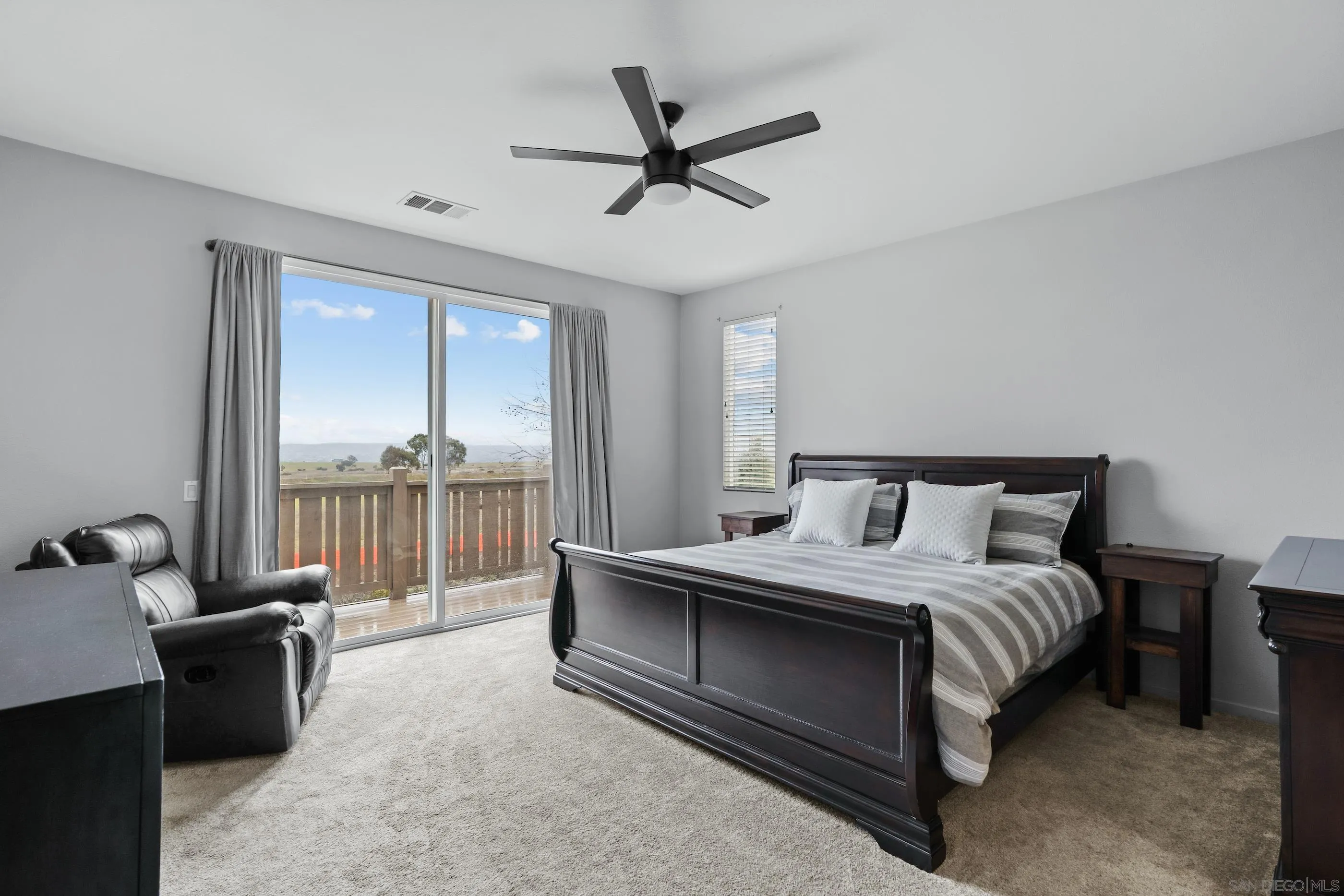 5481 San Roberto San Diego, CA 92154 - Photo 15 of 32 a bedroom with a bed and a large window