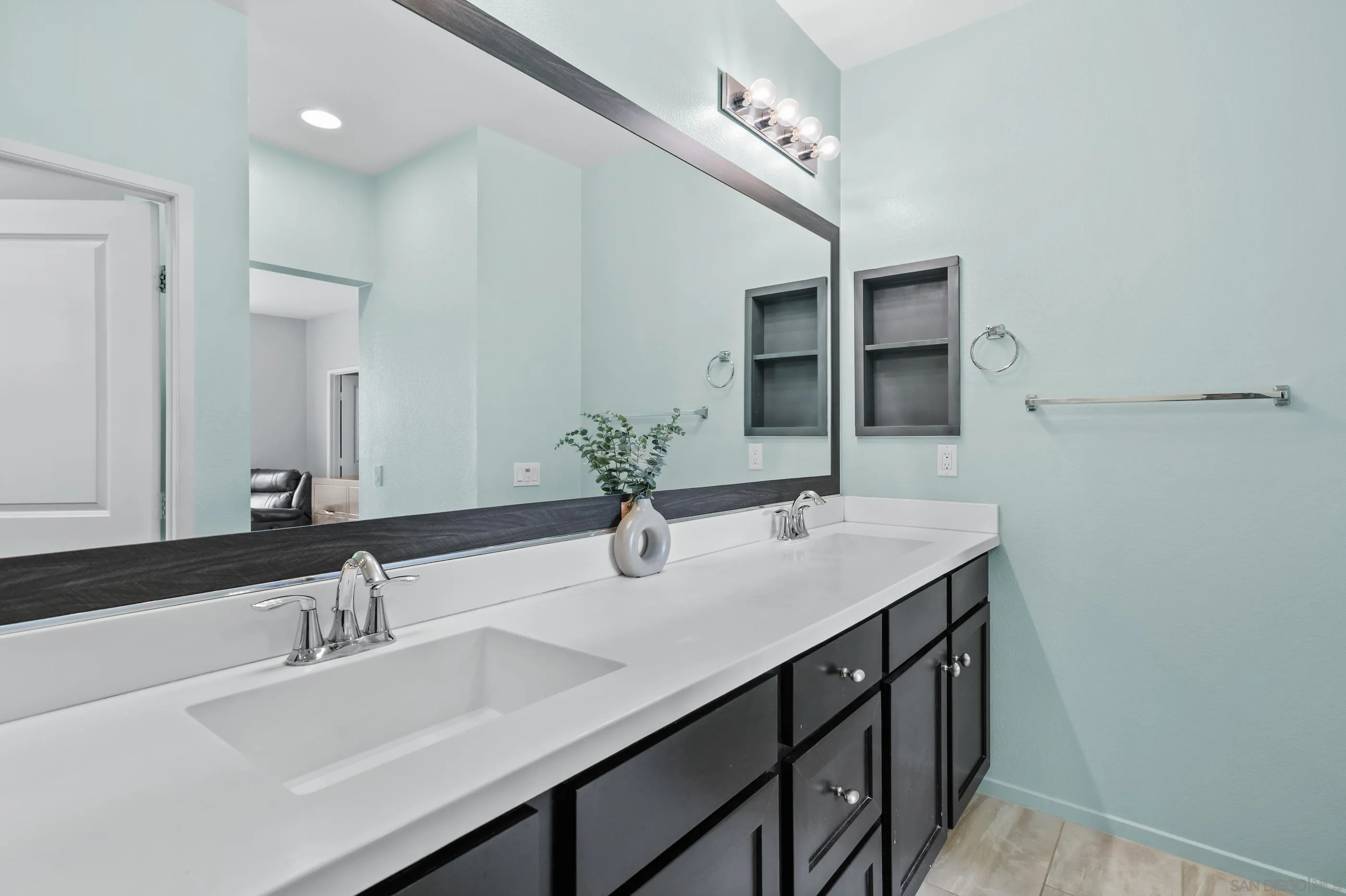 5481 San Roberto San Diego, CA 92154 - Photo 21 of 32 a bathroom with a sink and a mirror