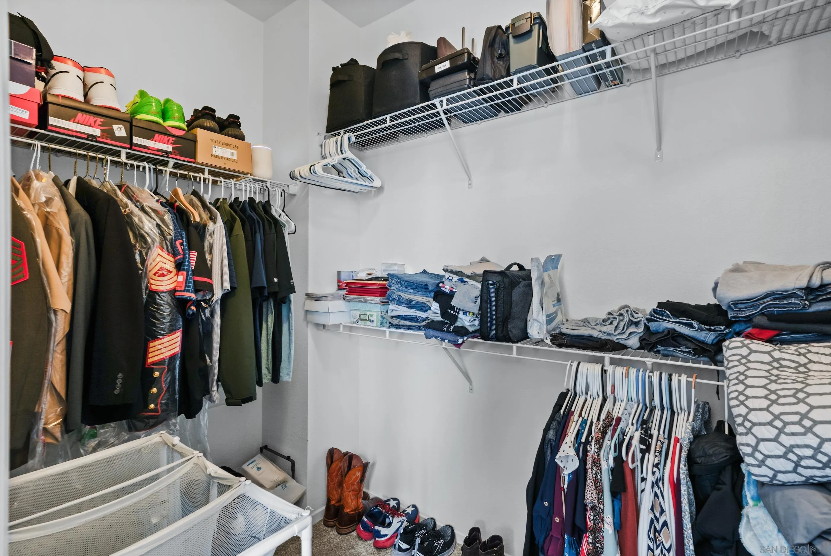 5481 San Roberto San Diego, CA 92154 - Photo 22 of 32 a view of walk in closet with clothes and shoes