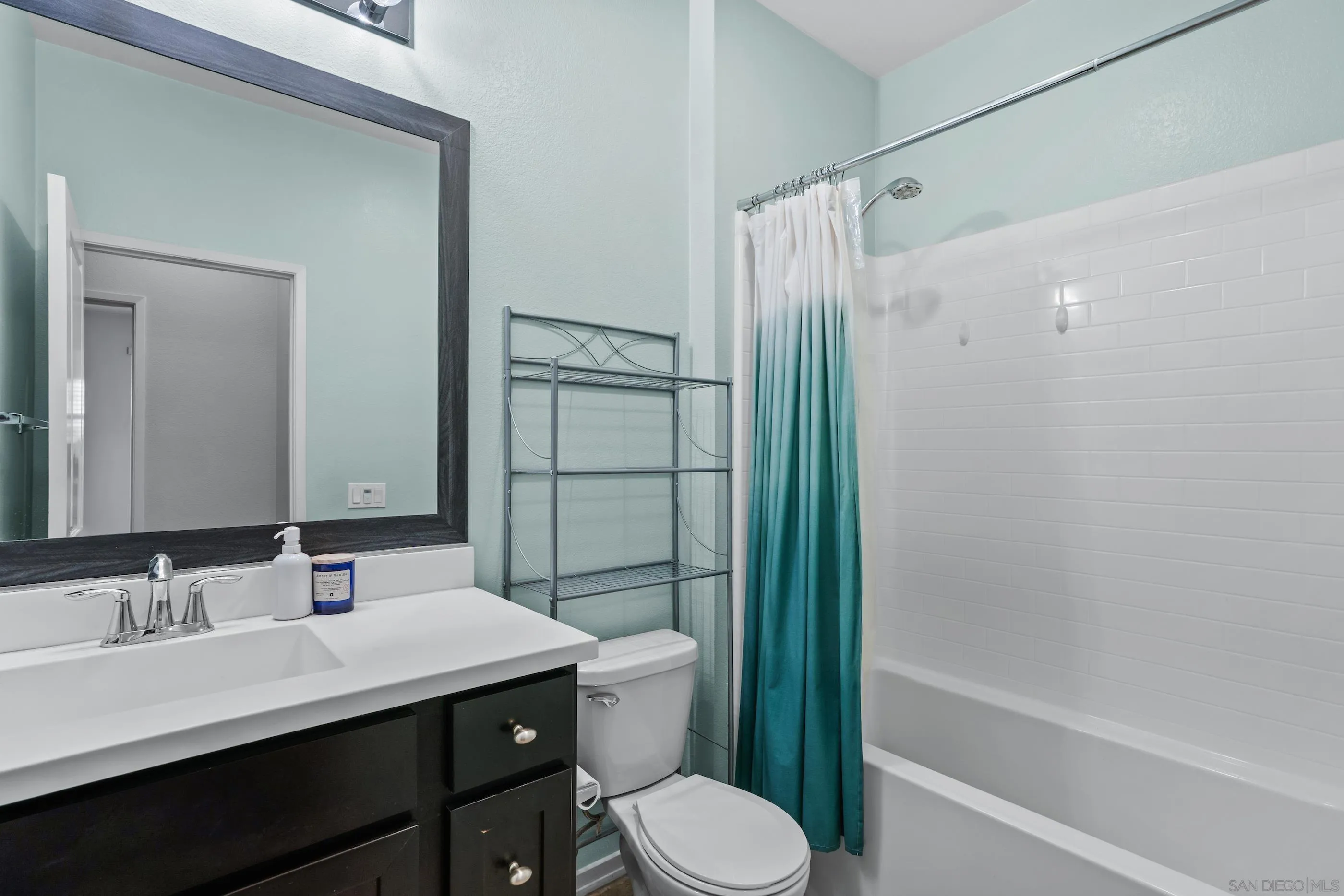 5481 San Roberto San Diego, CA 92154 - Photo 24 of 32 a bathroom with a sink vanity mirror and toilet