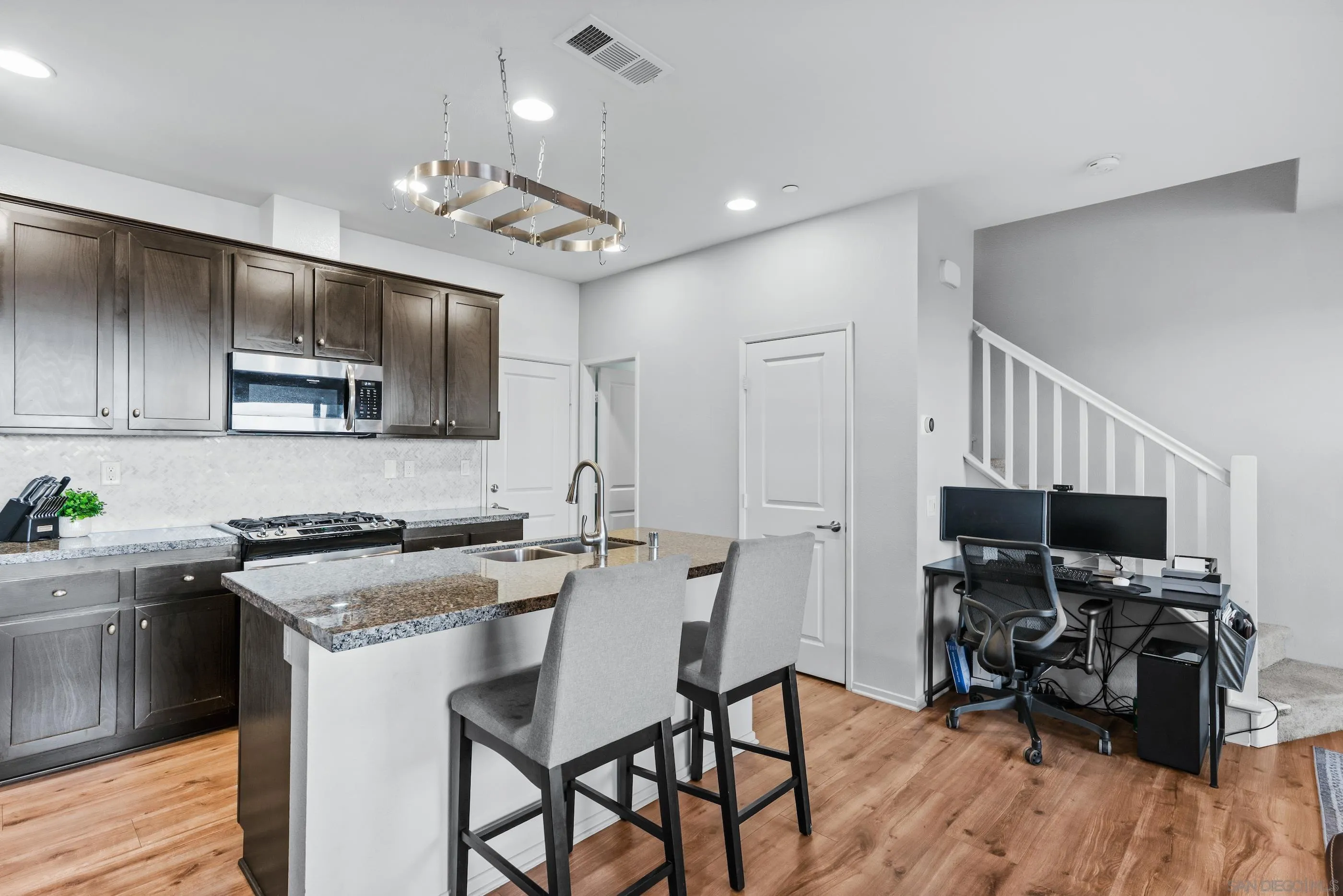 5481 San Roberto San Diego, CA 92154 - Photo 3 of 32 a kitchen that has a sink cabinets and wooden floor