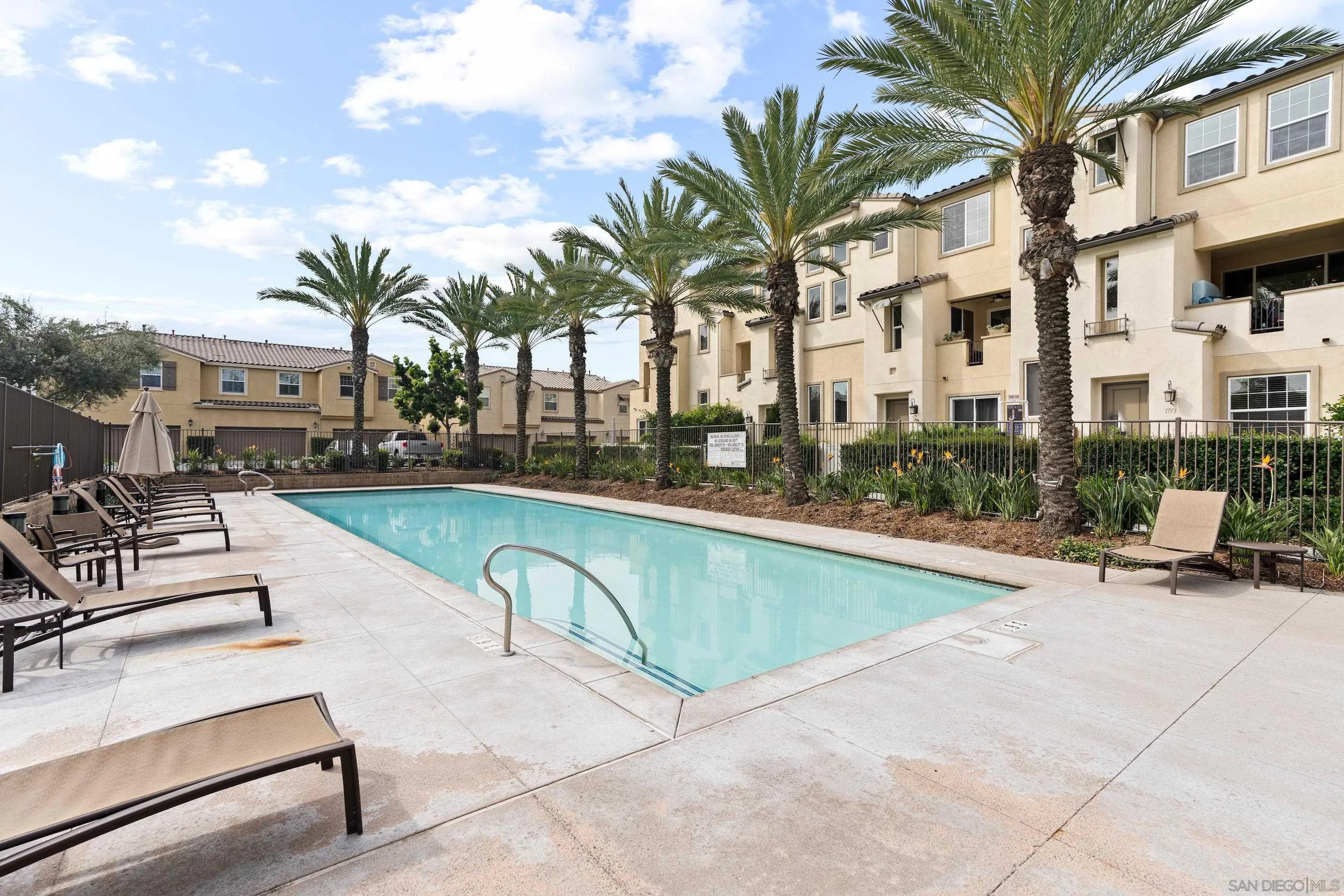 5481 San Roberto San Diego, CA 92154 - Photo 31 of 32 a view of swimming pool with outdoor seating and house in the background