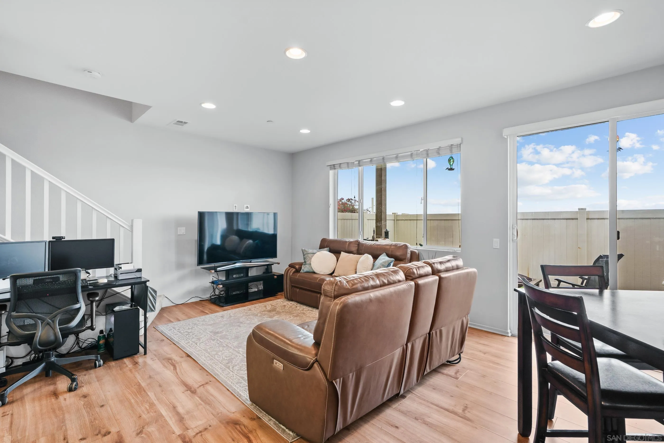 5481 San Roberto San Diego, CA 92154 - Photo 4 of 32 a living room with furniture a flat screen tv and wooden floor