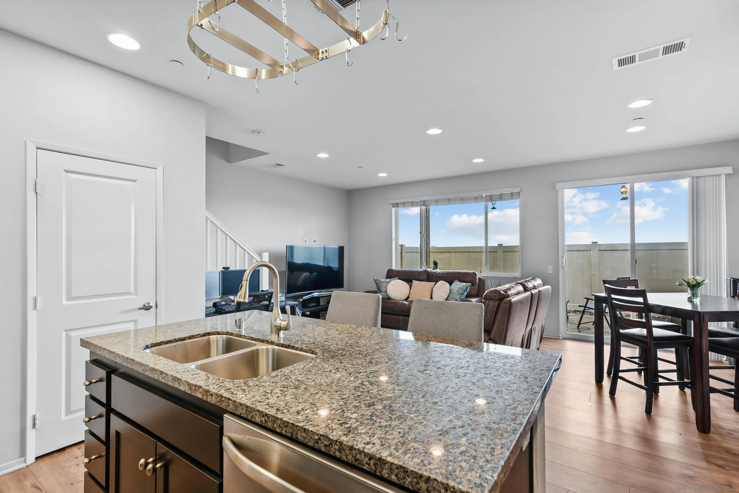 5481 San Roberto San Diego, CA 92154 - Photo 8 of 32 a view of kitchen island dining table and wooden floor