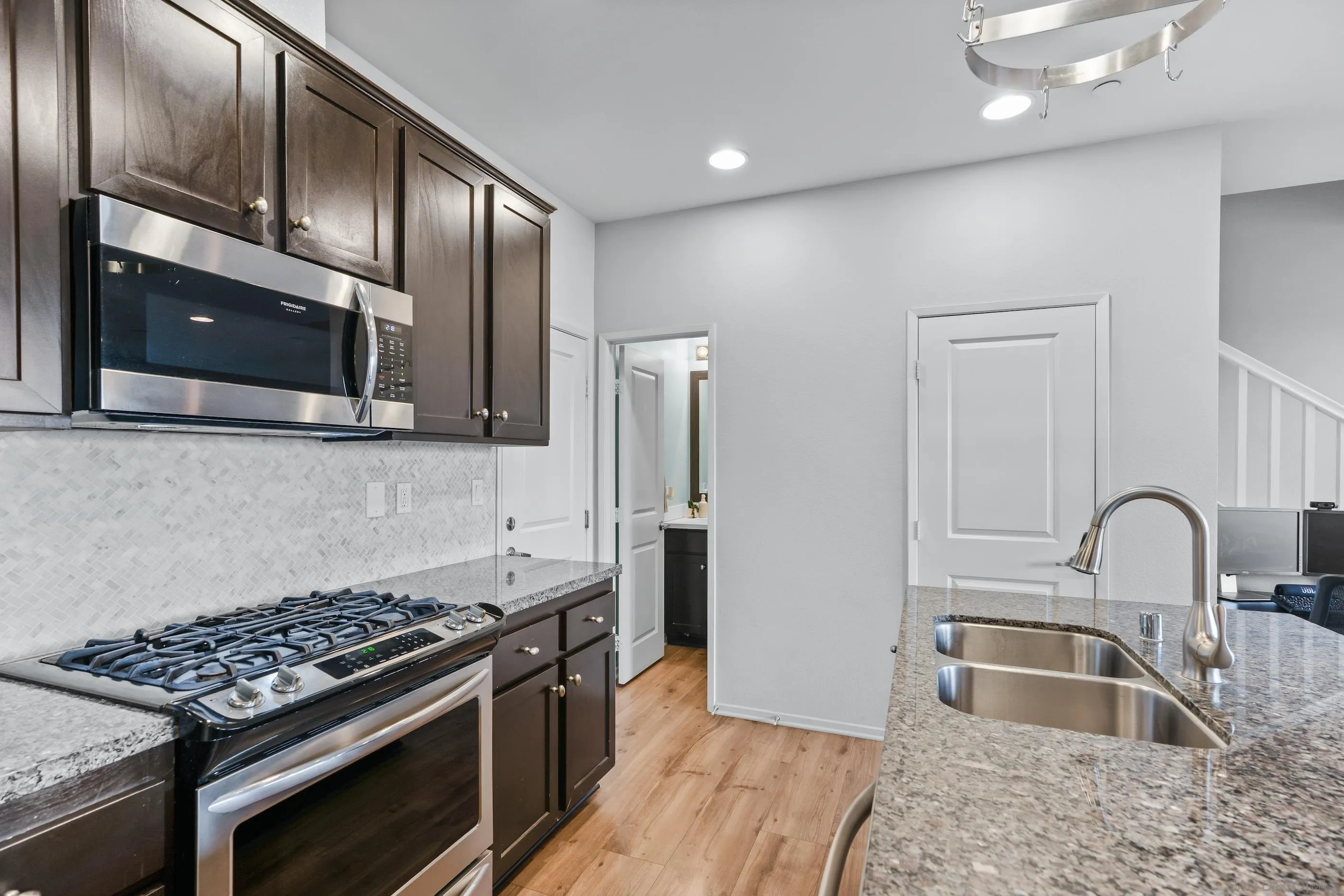 5481 San Roberto San Diego, CA 92154 - Photo 10 of 32 a kitchen with stainless steel appliances granite countertop a sink stove and refrigerator