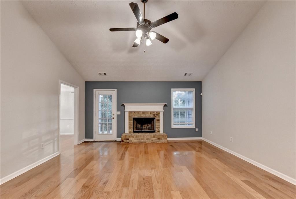310 Andrew Ridge Drive Jefferson, GA 30549 - Photo 8 of 52 wooden floor fireplace and windows in an empty room