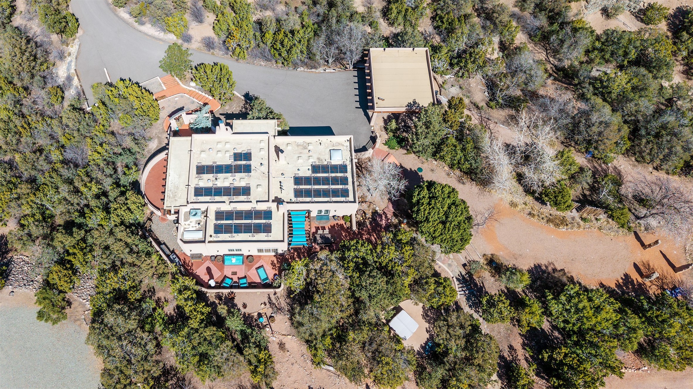 1204 Bandolina Road Santa Fe, NM 87501 - Photo 58 of 69 Main house (solar panels) and carport in center, meditation garden on right