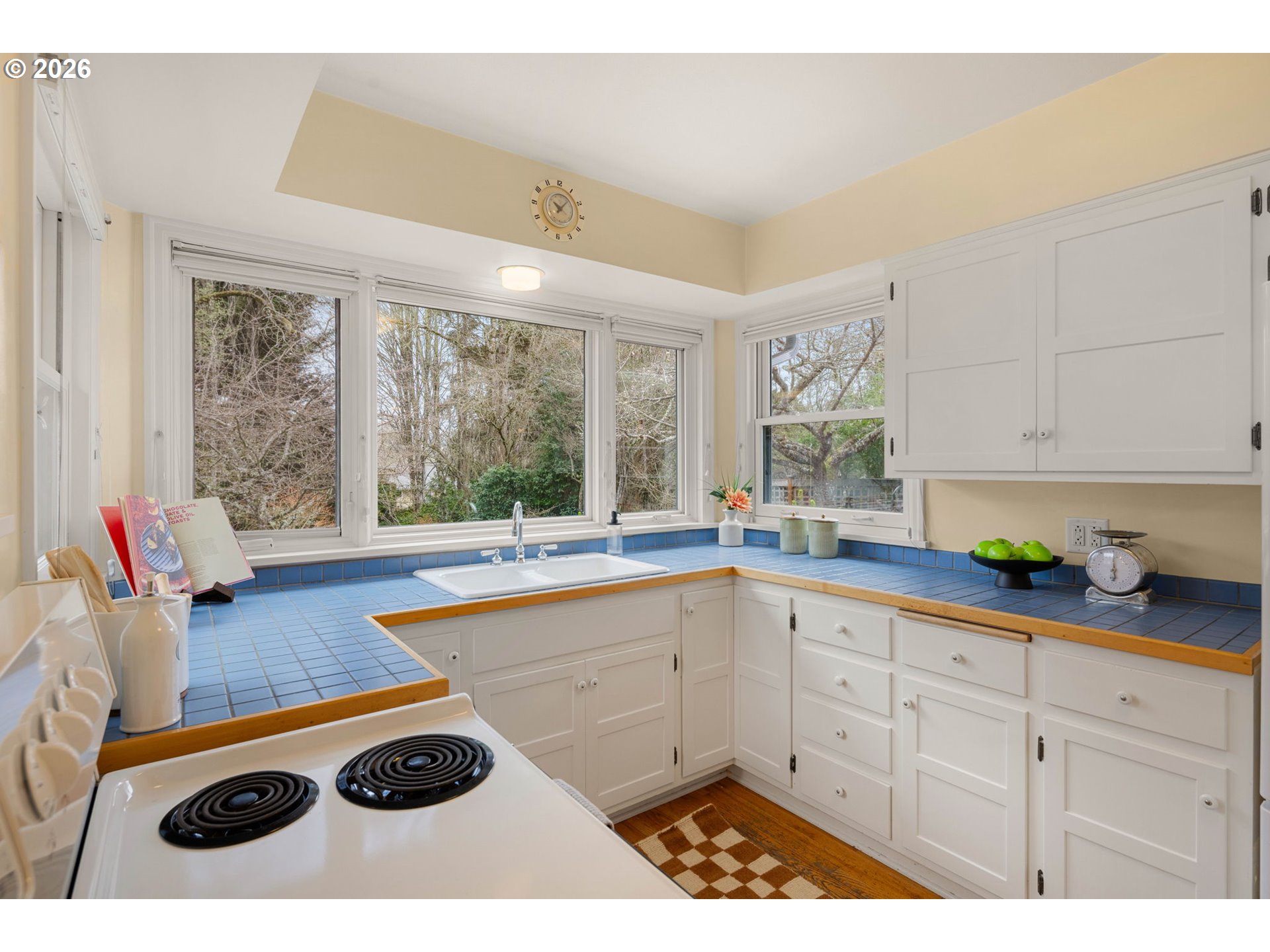 940 East 23rd Avenue Eugene, OR 97405 - Photo 27 of 48 a kitchen with a sink a stove and white cabinets