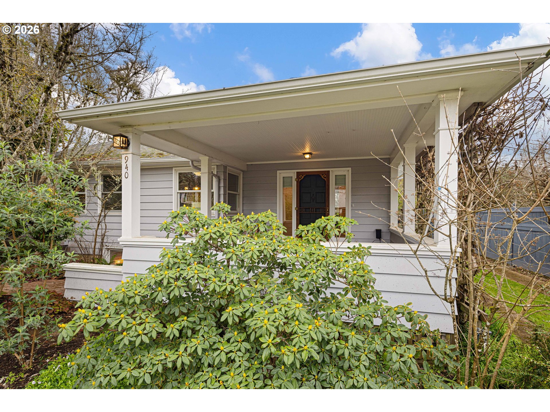 940 East 23rd Avenue Eugene, OR 97405 - Photo 3 of 48 a view of a house with a flower garden