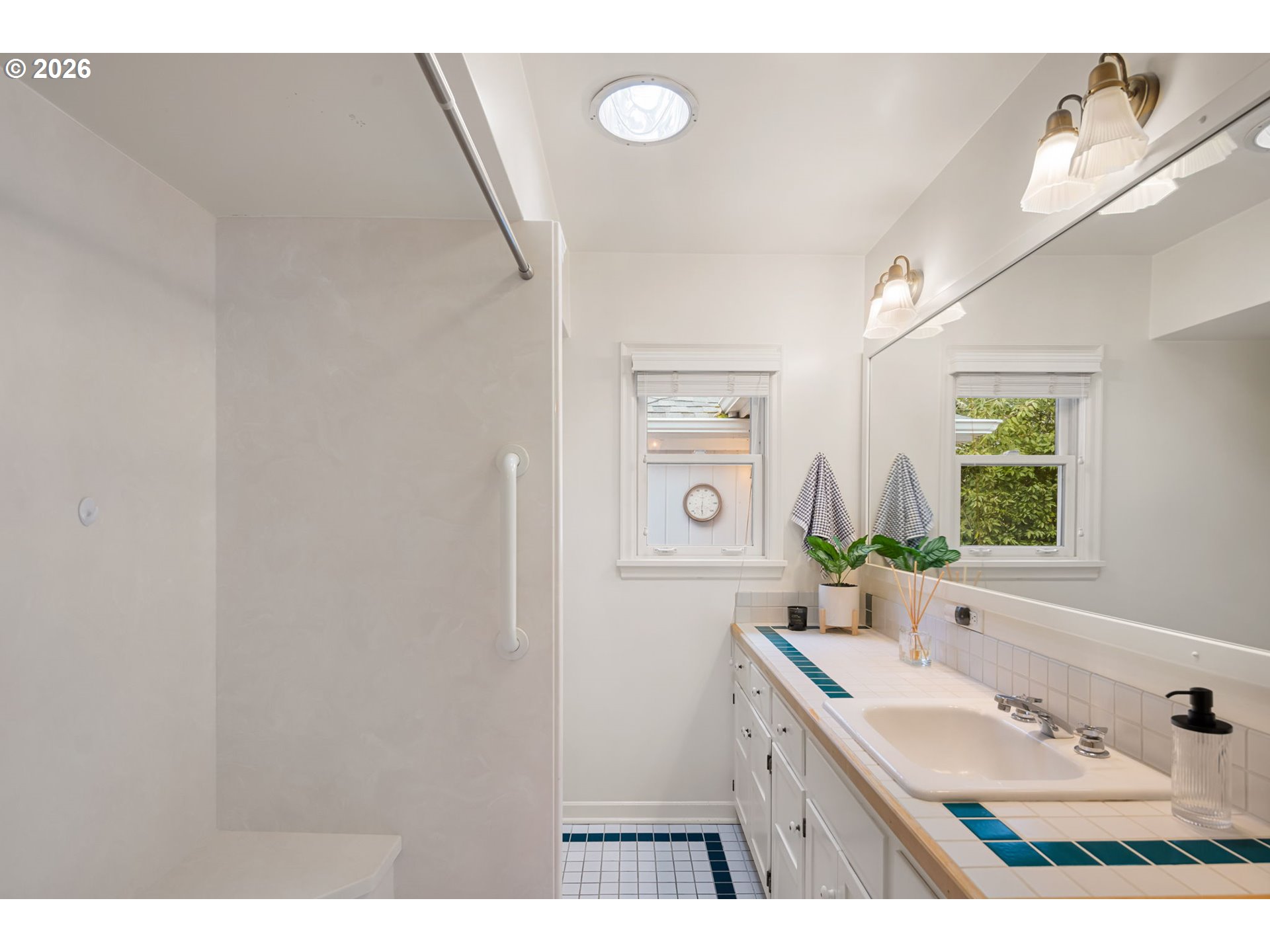 940 East 23rd Avenue Eugene, OR 97405 - Photo 36 of 48 a bathroom with a sink a mirror and a shower
